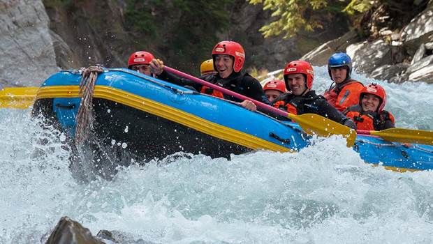 A rafting group look excitedly down at the the rapid they are about to take on, on Shotover River